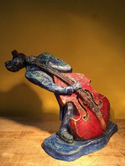 Ceramic sculpture of bass player.