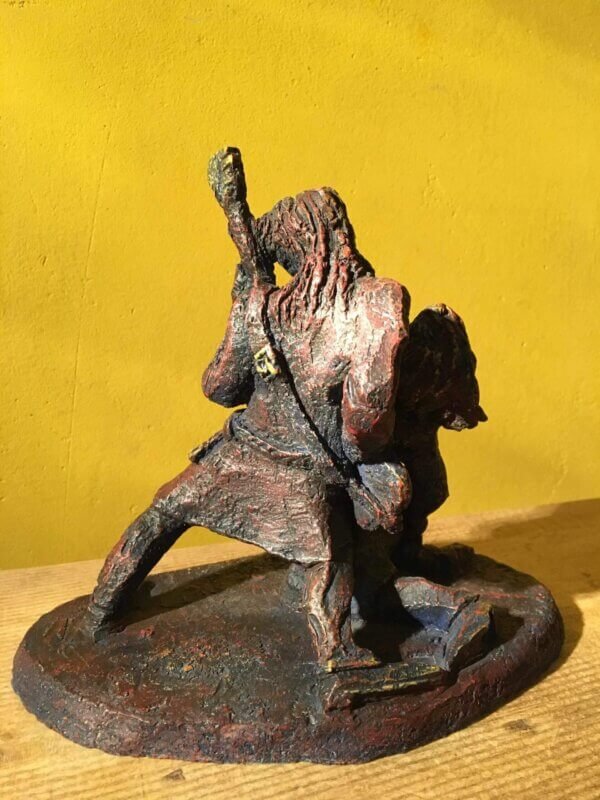 Ceramic sculpture of a singer and guitarist painted red.