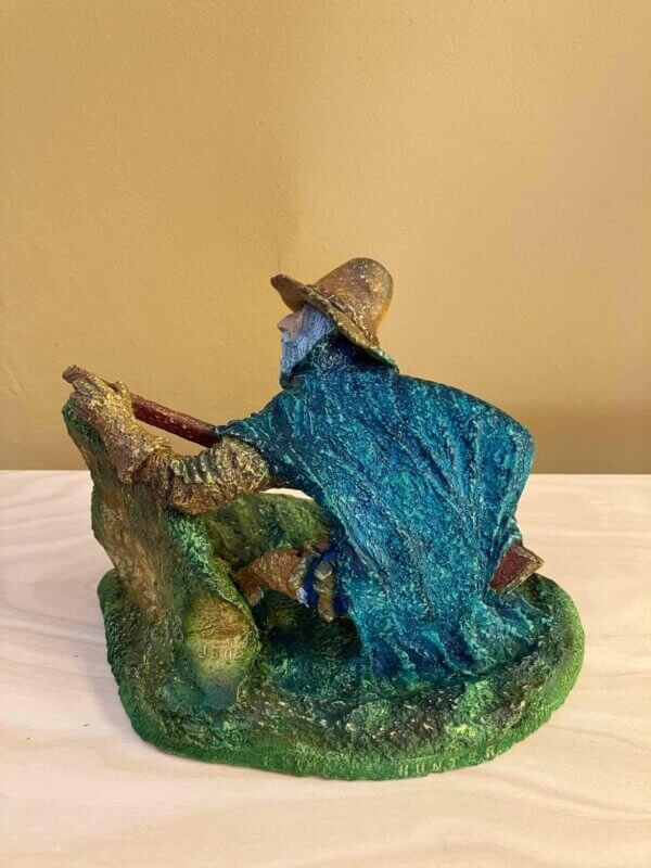 Ceramic sculpture of a Pilgrim Father hunter pointing a gun.