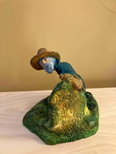 Ceramic sculpture of a Pilgrim Father hunter pointing a gun.