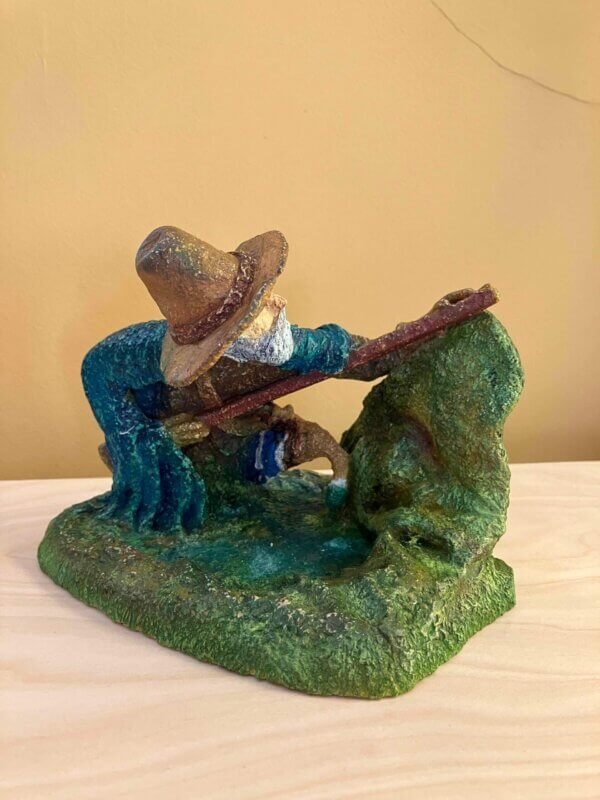 Ceramic sculpture of a Pilgrim Father hunter pointing a gun.
