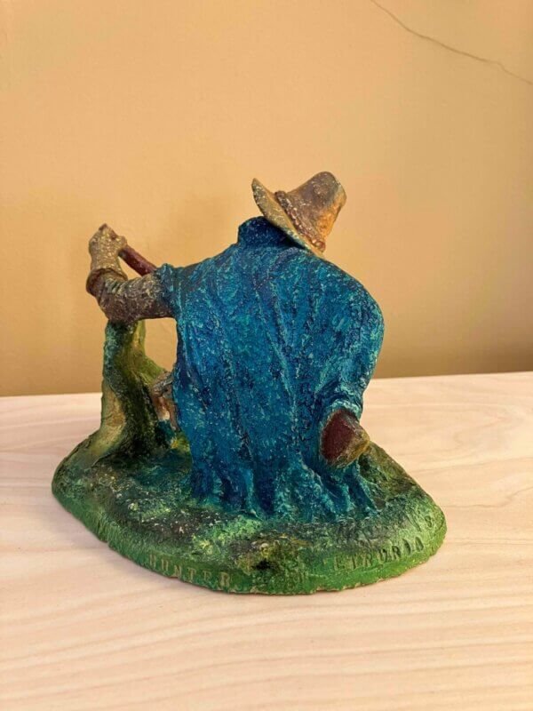 Ceramic sculpture of a Pilgrim Father hunter pointing a gun.