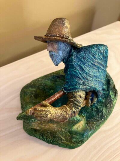 Ceramic sculpture of a Pilgrim Father hunter pointing a gun.