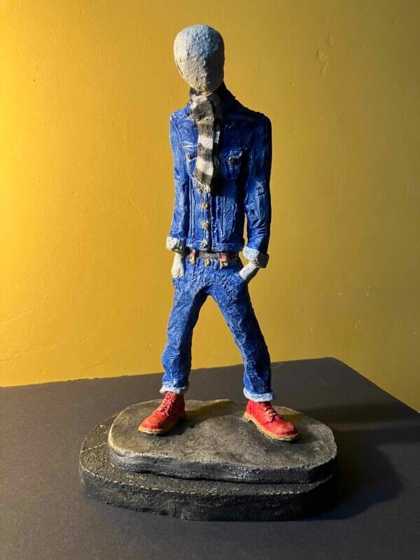 Ceramic sculpture of a skinhead in a black-and-white scarf