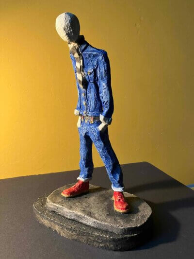 Ceramic sculpture of a skinhead in a black-and-white scarf