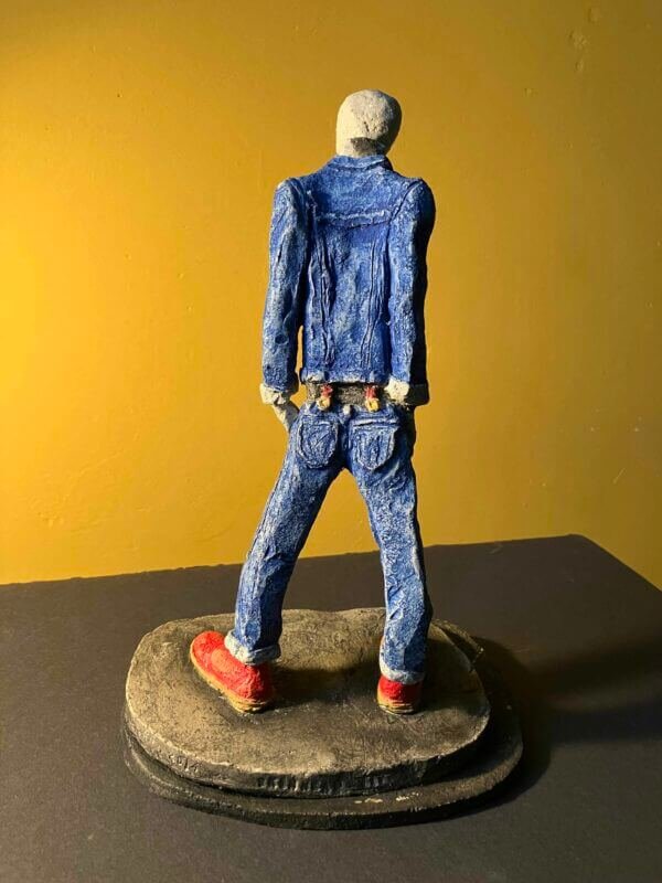 Ceramic sculpture of a skinhead in a black-and-white scarf