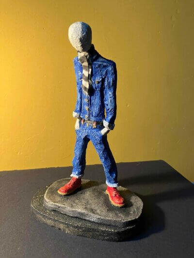 Ceramic sculpture of a skinhead in a black-and-white scarf