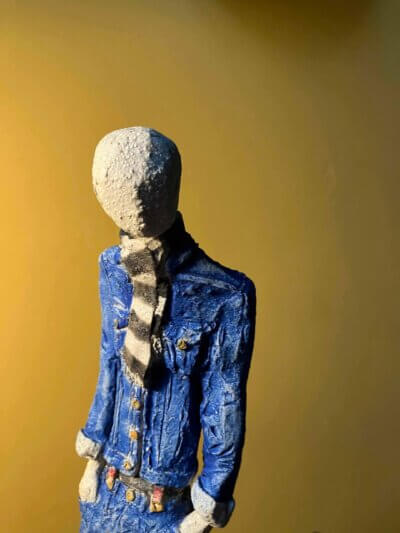 Ceramic sculpture of a skinhead in a black-and-white scarf