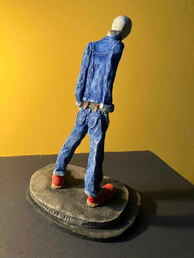 Ceramic sculpture of a skinhead in a black-and-white scarf
