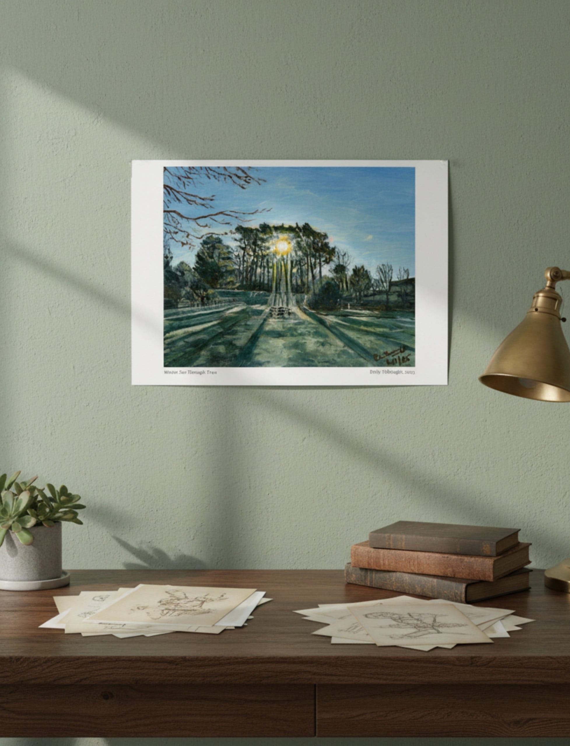 Winter Sun Through Trees Art Print shown on a green wall above a desk