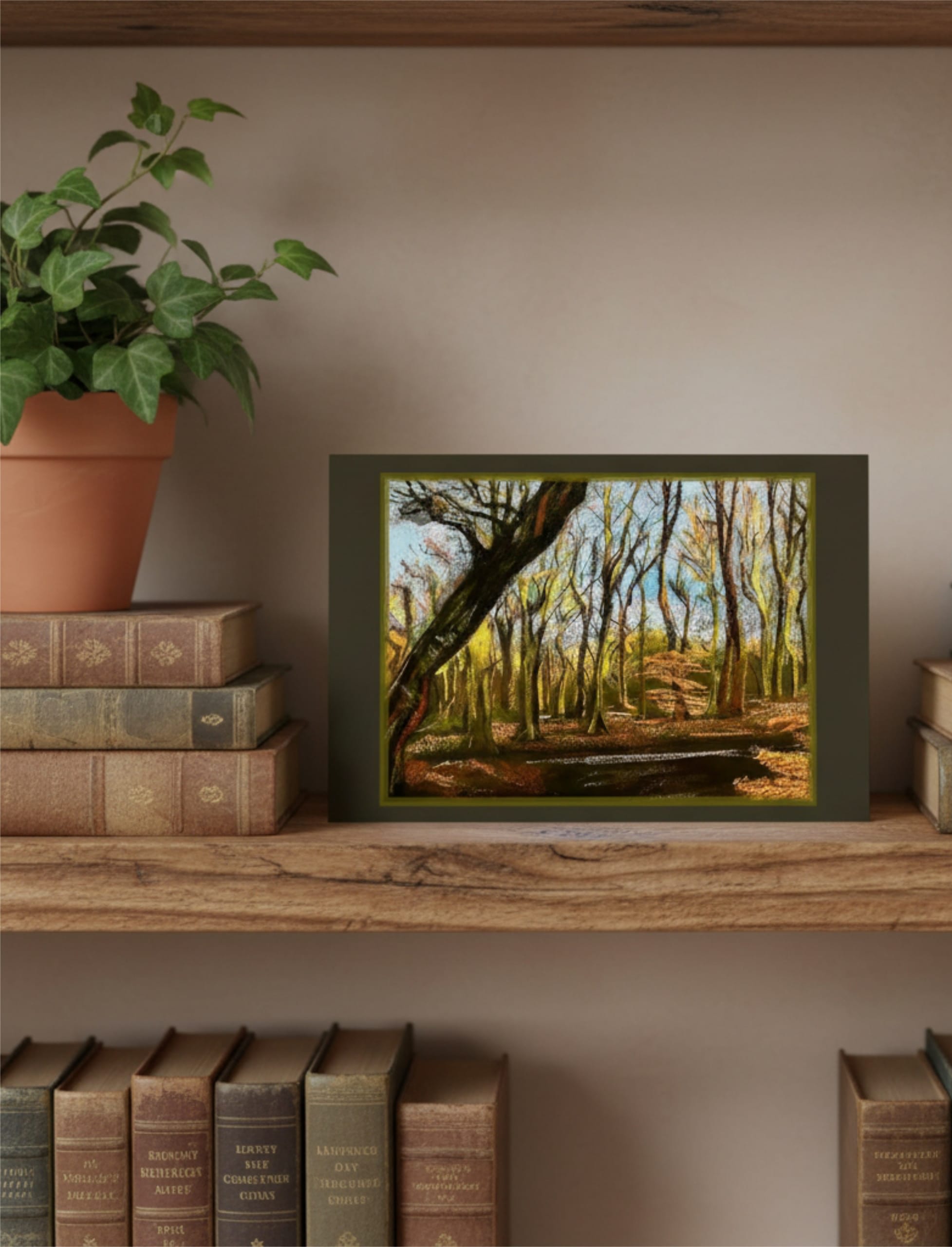 Winter Woodland greetings card on a shelf with ivy and books