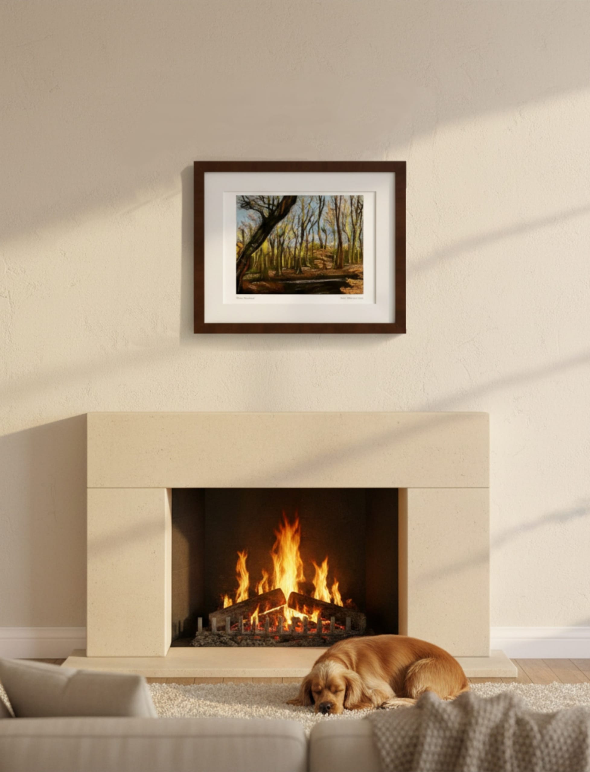 Winter Woodland Framed Art Print above a fire in a fireplace with a spaniel lying down