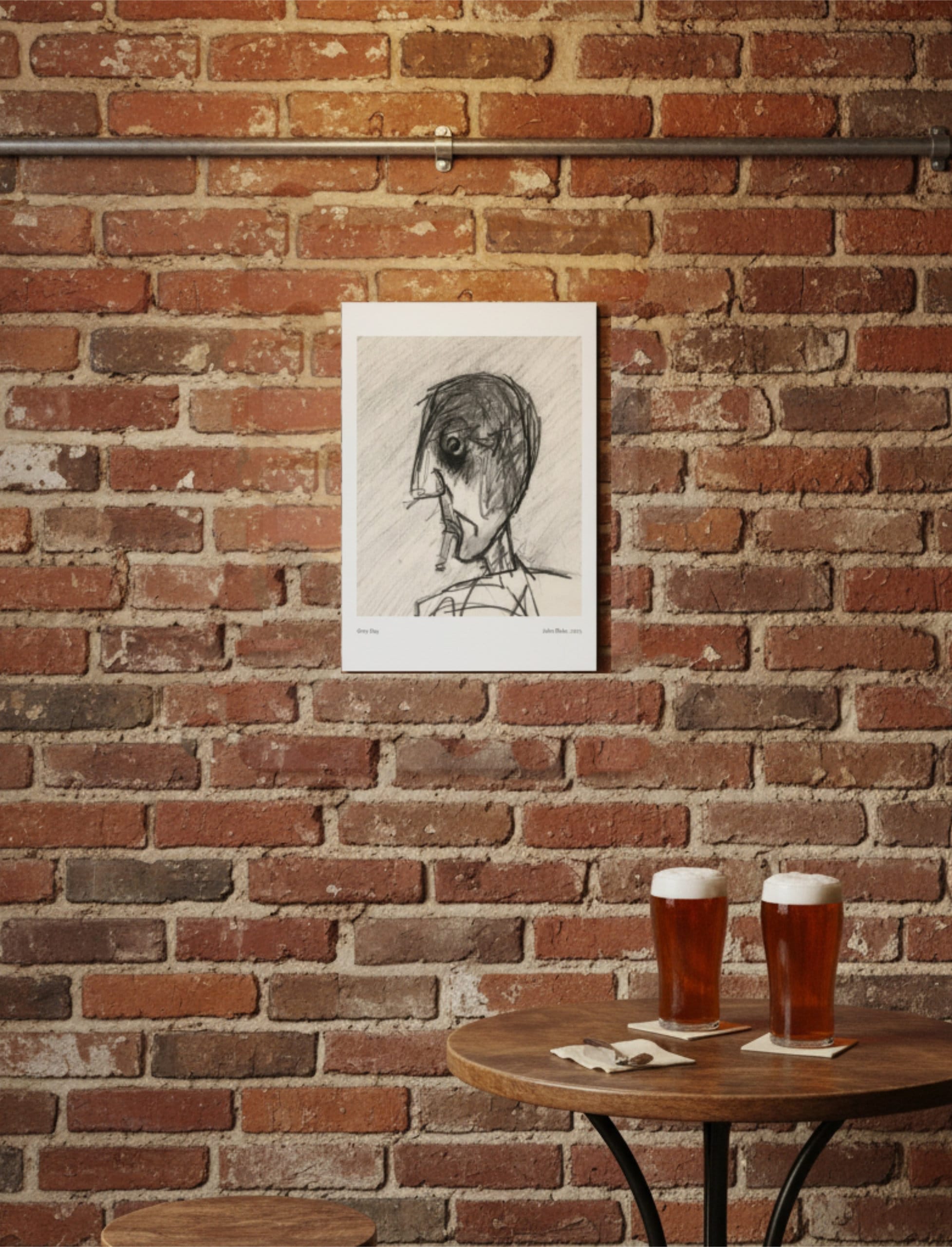 Grey Day Art Print A4 on a brick wall above a table with two pints of beer