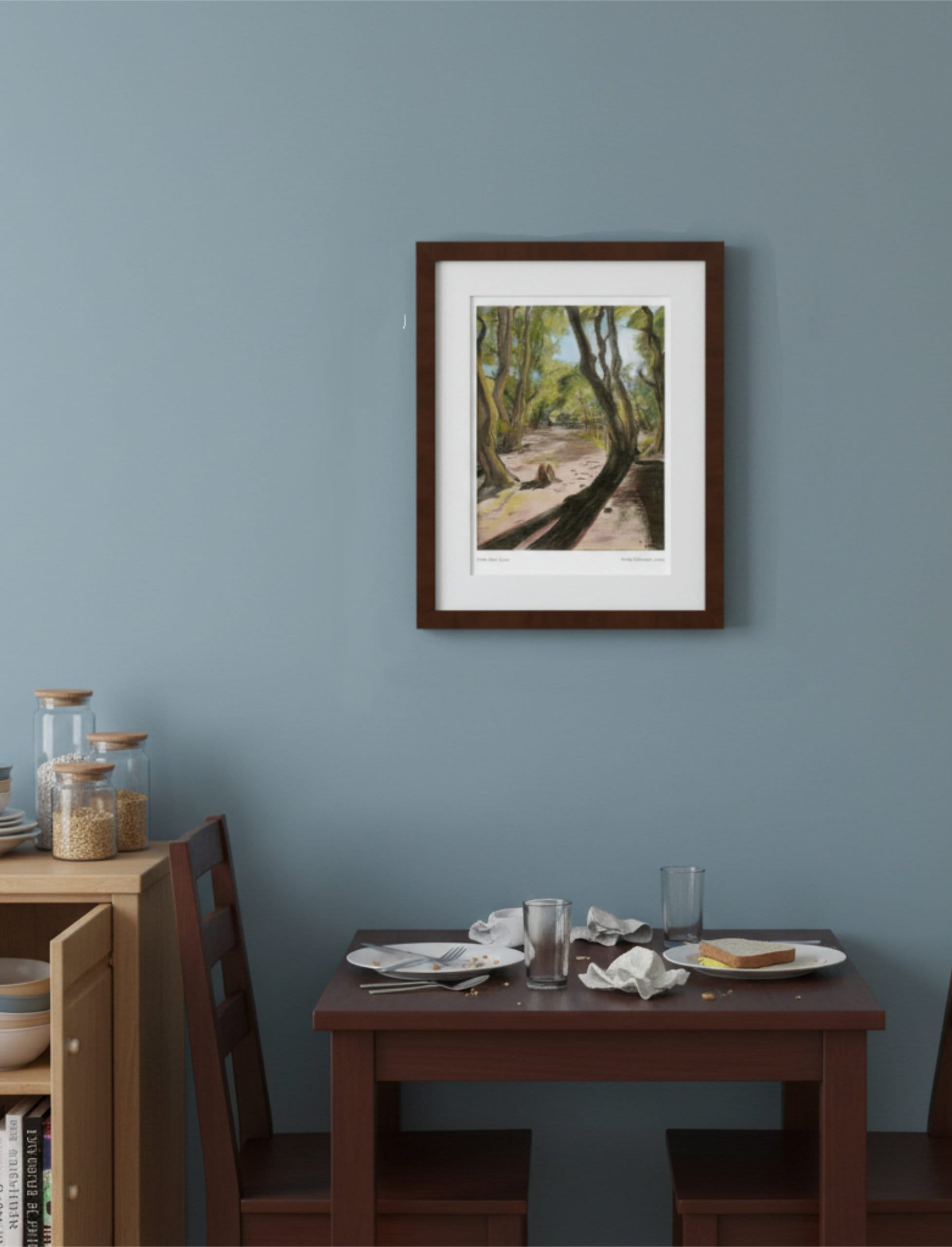 Path After Lines framed Art Print above a small dining table with food on and a kitchen shelf unit