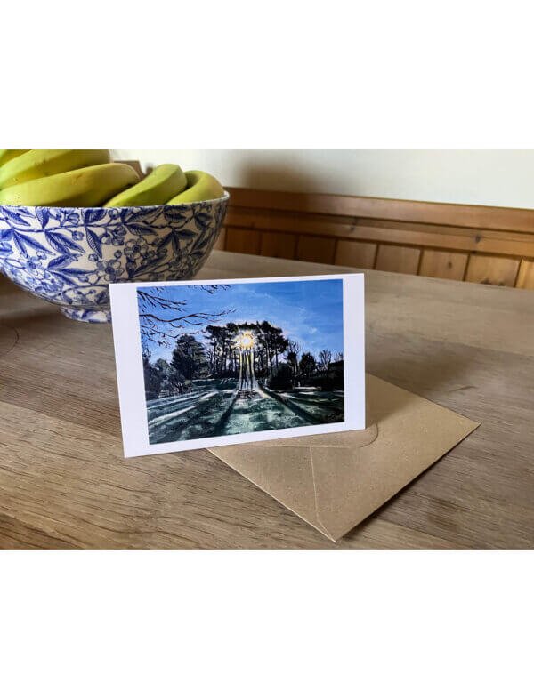 Greetings card showing an acrylic painting of sun shining through pine trees