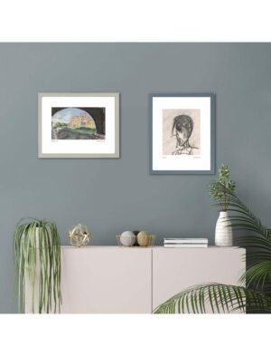 Two framed art prints on a wall