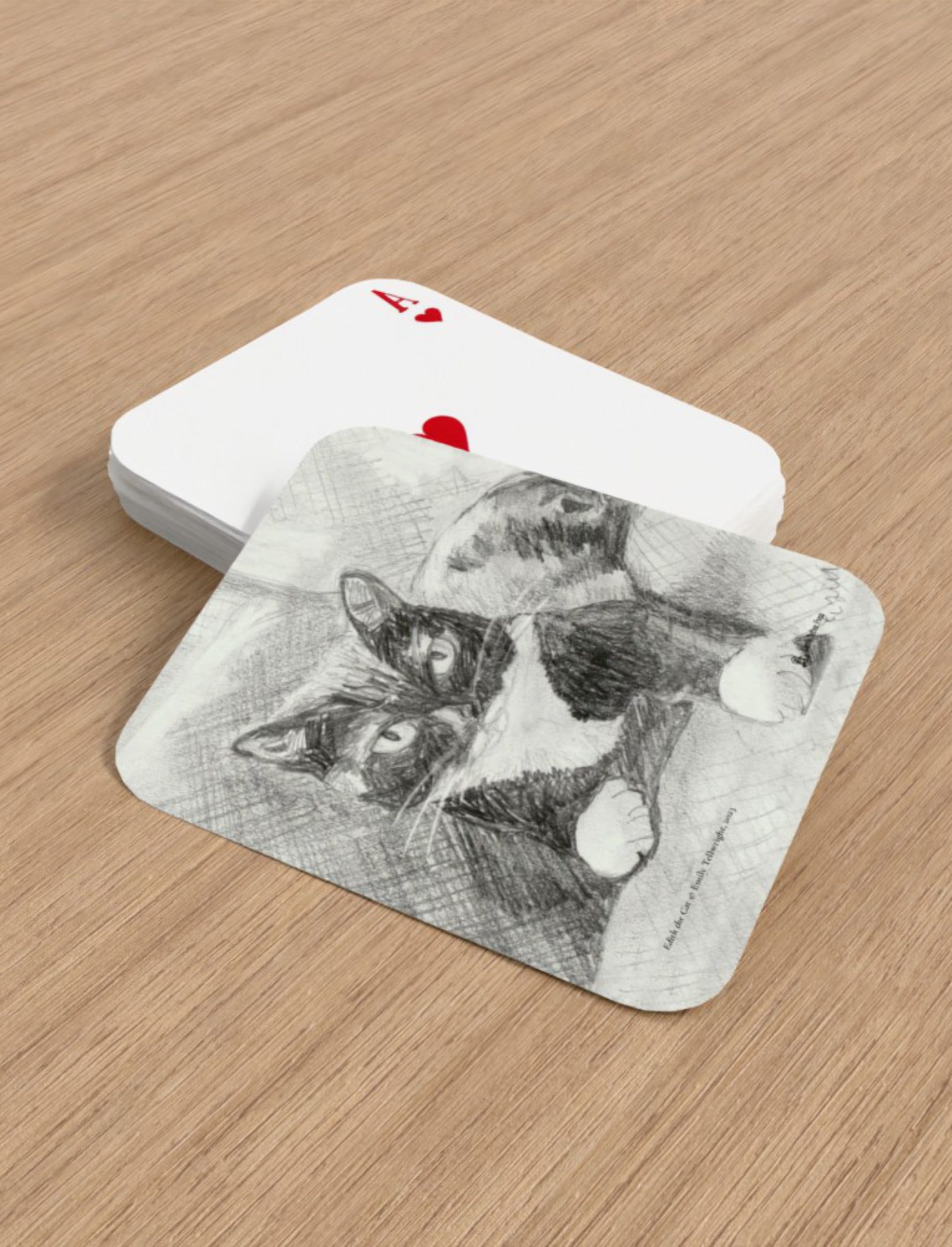 Edith the Cat playing cards showing. pencil drawing by Emily Tellwright