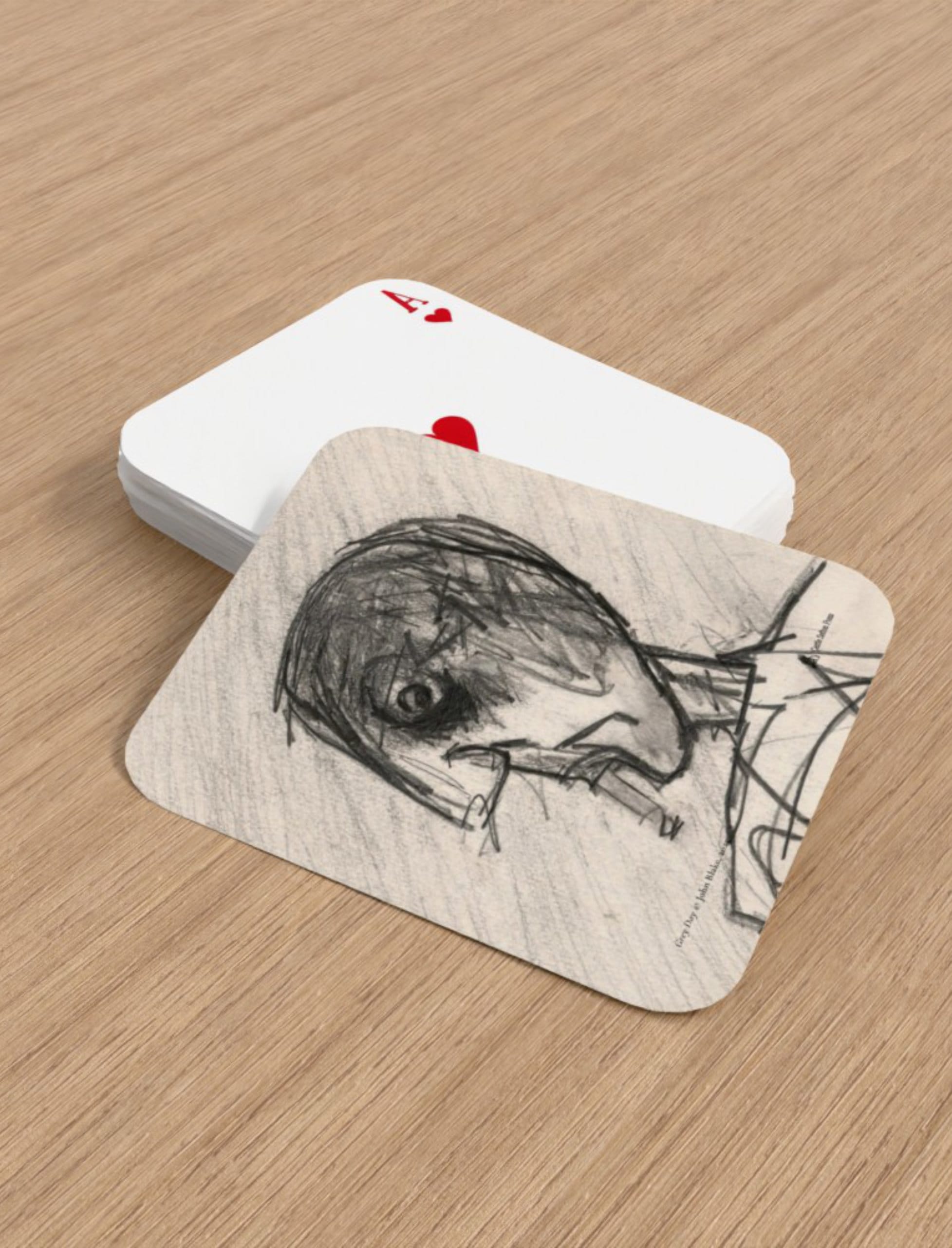 Grey Day Playing Cards showing a pencil drawing of a head smoking by John Blake