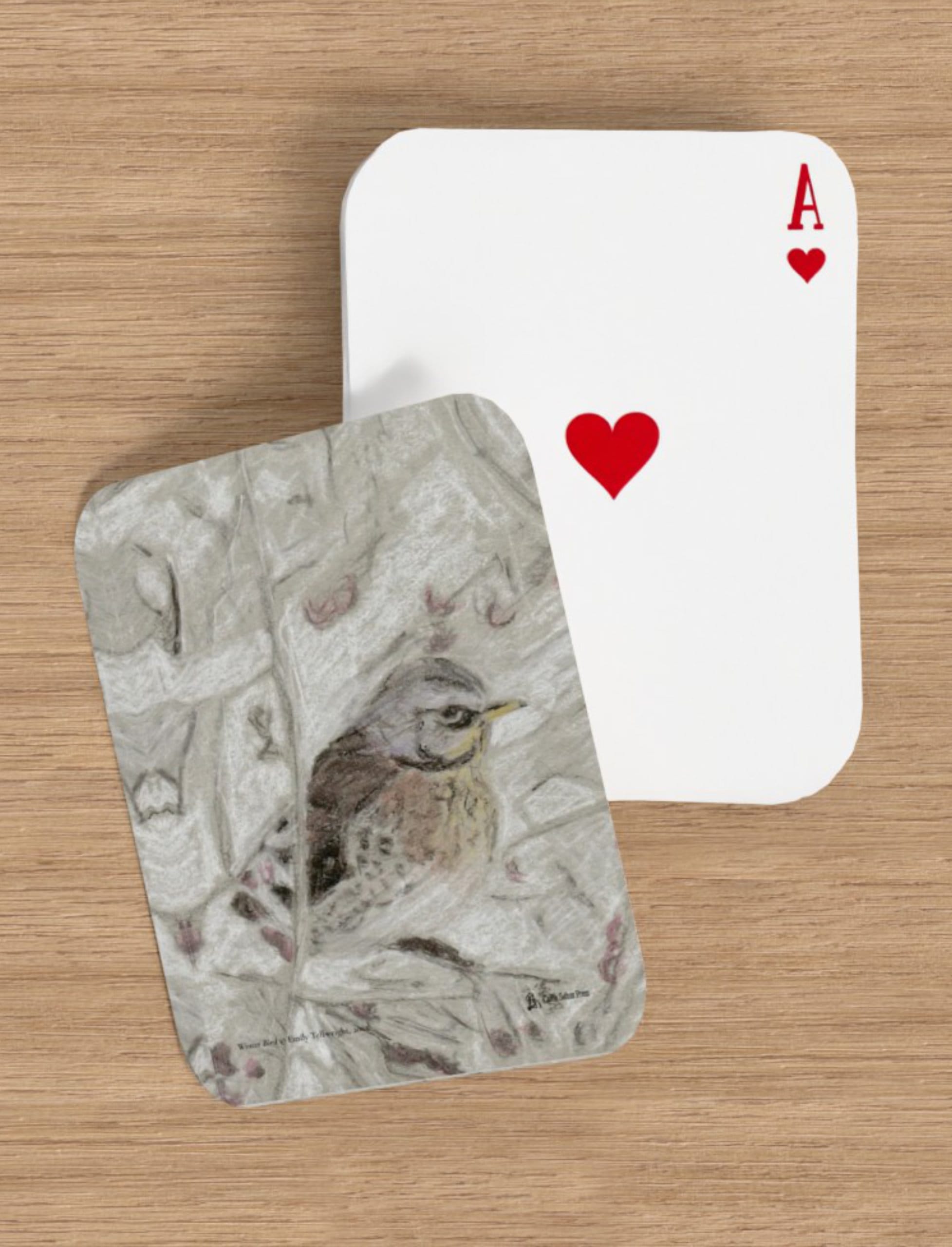 Winter Bird playing cards showing a drawing of a filedfare by Emily Tellwright